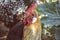 Close up of head of golden rooster standing on traditional rural barnyard in the morning. Portrait of colorful long-tailed rooster