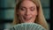 Close up head shot Caucasian 40s woman middle-aged adult businesswoman rich female holding fan counting money check