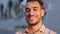 Close up head shot portrait in city outdoors Hispanic Arabian Latin Indian bearded businessman happy guy satisfied