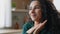 Close up head shot portrait peaceful beautiful young woman relaxing at home put chin on folded palms looking into