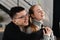 Close up head shot portrait of smiling happy young man and woman hugging and looking away. Attractive affectionate