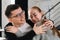 Close up head shot portrait of smiling happy young man and woman hugging and looking away. Attractive affectionate