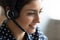 Close up head shot smiling friendly Indian woman wearing headset