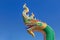 Close up head of thai dragon or serpent king statues in buddhist thai temple on blue sky background