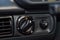 Close-up on the headlight switch control buttons and automatic adjust level dashboard in retro old car in the vehicle repair