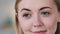 Close up headshot calm smiling Young lady millennial posing indoors in room, enjoying weekend time. Healthy girl feels