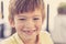 Close up headshot portrait of young little 7 or 8 years old boy with sweet funny teeth smiling happy and cheerful in joy face expr