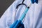 Close up of health worker inserting syringe into test tube with chemical