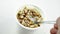 Close-up of healthy cereal and chocolate and white yogurt on the spoon