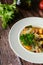 Close-up of healthy vegan minestrone with sweet potatoes, celery, tomatoes and beans.