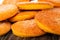 Close up of heap orange cookies on wooden table