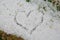 CLOSE UP HEART DRAWING ON LARG FRESHLY HAIL STONES IN GRASS