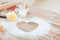 Close up of heart of flour on wooden table at home