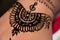 A close-up henna tattoo on a woman hand. Mehndi is a form of body art