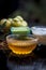 Close up of herbal face pack of Indian gooseberry or amla with curd or yogurt and honey in a glass bowl on wooden surface used to