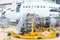 Close-up of high-bypass turbofan aircraft engine near to a passenger aircraft in a hangar