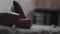 Close up high heels shoes on the carpet and silhouette of a walking kid at the background