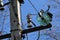 Close-up of high-voltage power lines and power pylons against a blue sky.