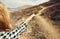 Close up of hiker woman\\\'s hands pointing her finger at hiking trail on top of the mountain, Tenerife, Canary Islands, Spain