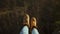 Close up hiking boots of Independent Woman traveller on top of mountain looking at view. Hiker girl dangling feet over