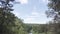 Close up of hipster hiker observing the the green valley on blue cloudy sky background. Stock footage. A bearded man