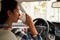 Close-up of Hispanic female driver drinking coffee in car