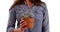 Close up of Hispanic woman in casual shirt holding small cactus in studio