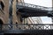 Close up of historic, renovated Butler`s Wharf warehouse building and iron bridges at Shad Thames, London.