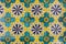 close up of historical vibrant multicolor square ceramic tiles with large geometric decorative patterns floor background