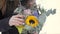 Close-up, holding a bouquet of flowers on a winter day