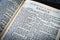 Close up of Holy Bible page, shallow depth of field with focus on book chapter, heading