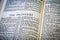 Close up of Holy Bible page, shallow depth of field with focus on book chapter, heading