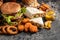 Close-up of home made tasty burger and hot dogs with fried chicken french fries. raditional American food. fast food