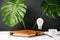 Close up of home office desk table workspace with a notebook, light bulb, pen, cup coffee, green leaf and eyeglasses