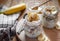 Close-up of homemade banana oats in a glass jar on wooden background