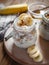 Close-up of homemade banana oats in a glass jar on wooden background