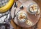 Close-up of homemade banana oats in a glass jar on wooden background, top view