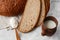 Close-up of homemade bread. Peasant round bread and wheat spikelets with space for text. Homemade baking. Sliced brown bread with