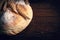 Close-up of homemade bread. Peasant round bread and wheat spikelets on a wooden background with space for text. Homemade baking