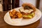 Close up of a homemade hamburger with spicy potatoes