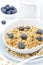 Close-up of homemade muesli, blueberries and jug of milk