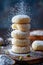 Close up of Homemade Powdered Sugar Doughnuts Stacked with Sugar Sprinkling Down on Rustic Background