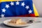 Close up of homemade `tres leches` cake, a traditional venezuelan dessert with milk and cinnamon powder with venezuelan flag in