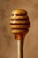 Close-up of a honey dipper with honey dripping down.