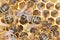 Close up of honeybees in beehive with bee eggs and larvae behind.