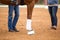 Close up of horse legs in the arena and coach standing near