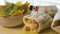 Close up of a hot fresh burrito and nachos with guacamole cream.