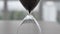 Close-up of an hourglass on a blurred background. Time is fleeting