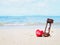 Close up hourglass and cushion heart shape with word LOVE on summer beach