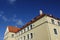 Close up of a house facade with red tiled roof. Clear blue sky background. Bottom up view. Sunny nautical day